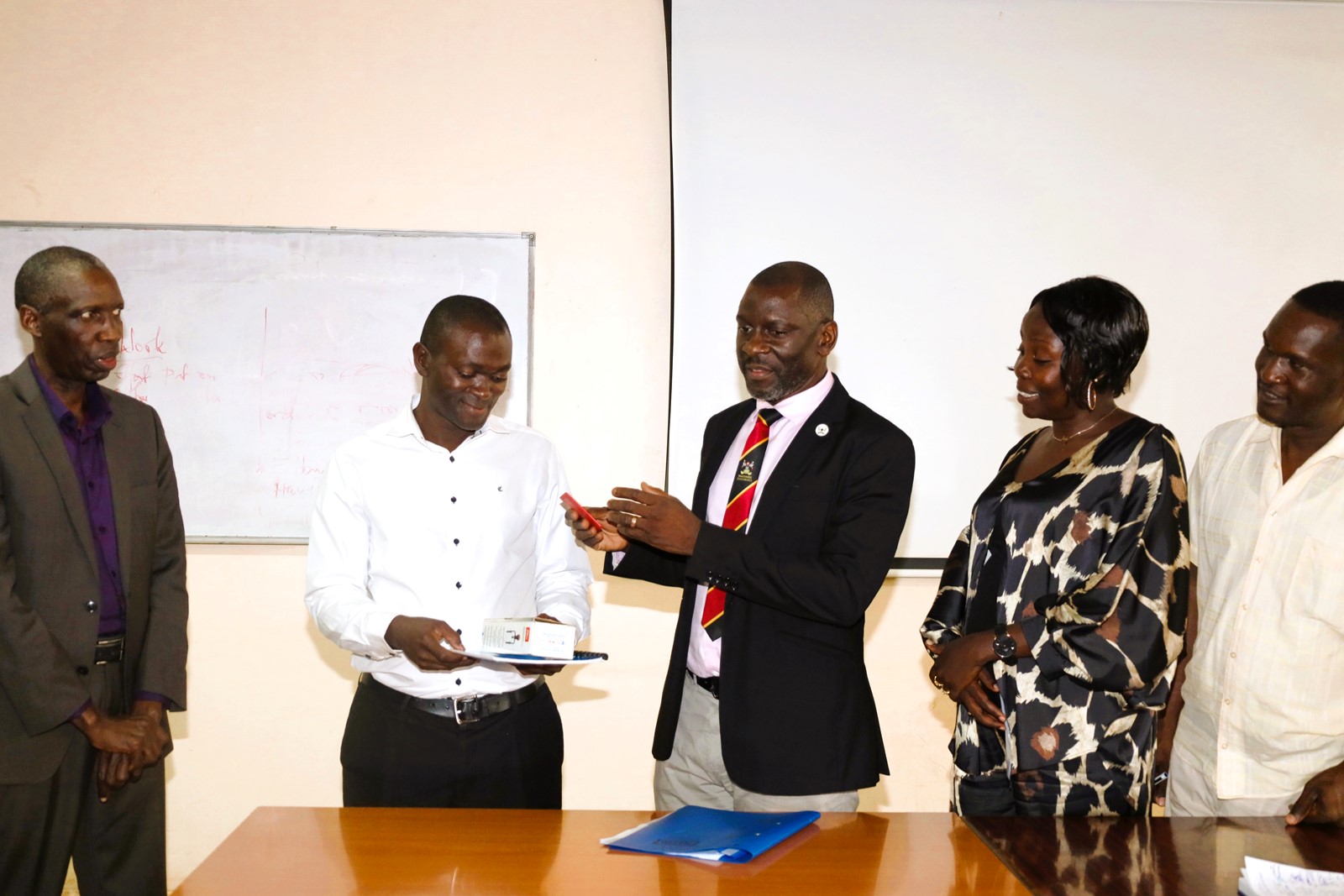 Left to Right: Principal CEES-Prof. Anthony Muwagga Mugagga, Incoming Dean-Prof. Jude Ssempebwa, Outgoing Dean-Dr. Julius Kikooma, CEES HR Officer-Ms. Janet Nabukeera, and Internal Auditor-Mr. Aggrey Luwuliza at the handover ceremony. East African School of Higher Education Studies and Development (EASHESD), College of Education and External Studies (CEES), Makerere University, Kampala Uganda, East Africa, Deanship Handover, 9th September 2024.