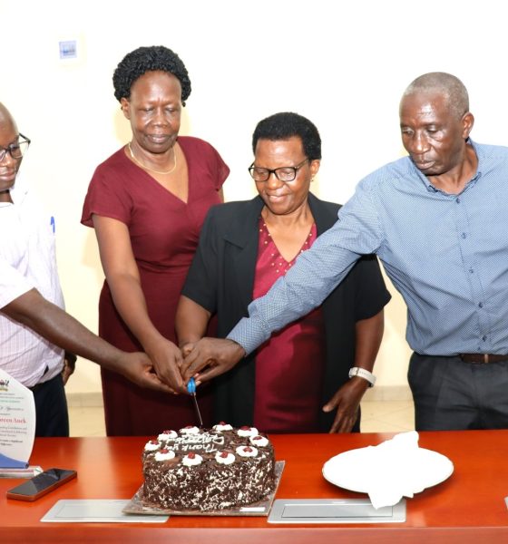 Left to Right: Dr. Justus Twesigye, Dean of the School of Social Sciences cuts cake with Retirees: Ms. Doreen Anek, Ms. Kitty Tweyanze and Mr. Jackson Byamugisha. School of Social Sciences, College of Humanities and Social Sciences (CHUSS), Makerere University, Kampala Uganda, East Africa, farewell ceremony to honor three retired staff members for their exemplary service. Retirees Ms. Doreen Anek, the Senior Assistant Registrar; Ms. Kitty Tweyanze, Senior Administrative Secretary; and Mr. Jackson Byamugisha, a Security guard, 2nd September 2024.