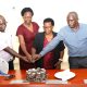 Left to Right: Dr. Justus Twesigye, Dean of the School of Social Sciences cuts cake with Retirees: Ms. Doreen Anek, Ms. Kitty Tweyanze and Mr. Jackson Byamugisha. School of Social Sciences, College of Humanities and Social Sciences (CHUSS), Makerere University, Kampala Uganda, East Africa, farewell ceremony to honor three retired staff members for their exemplary service. Retirees Ms. Doreen Anek, the Senior Assistant Registrar; Ms. Kitty Tweyanze, Senior Administrative Secretary; and Mr. Jackson Byamugisha, a Security guard, 2nd September 2024.