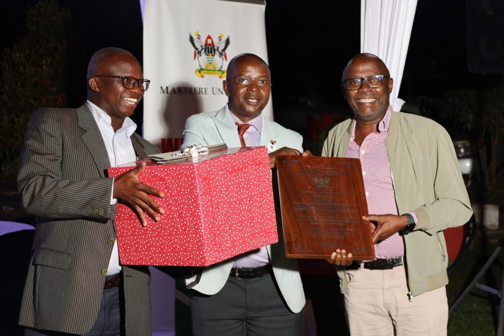 Dr. Joseph Wasswa Matovu (Right) receives his gift from Prof. Edward Bbaale (Centre) and Prof. James Wokadala (Left). College of Business and Management Sciences (CoBAMS) celebrates retiring staff and former leaders, 13th September 2024, Makerere University, Kampala Uganda, East Africa.