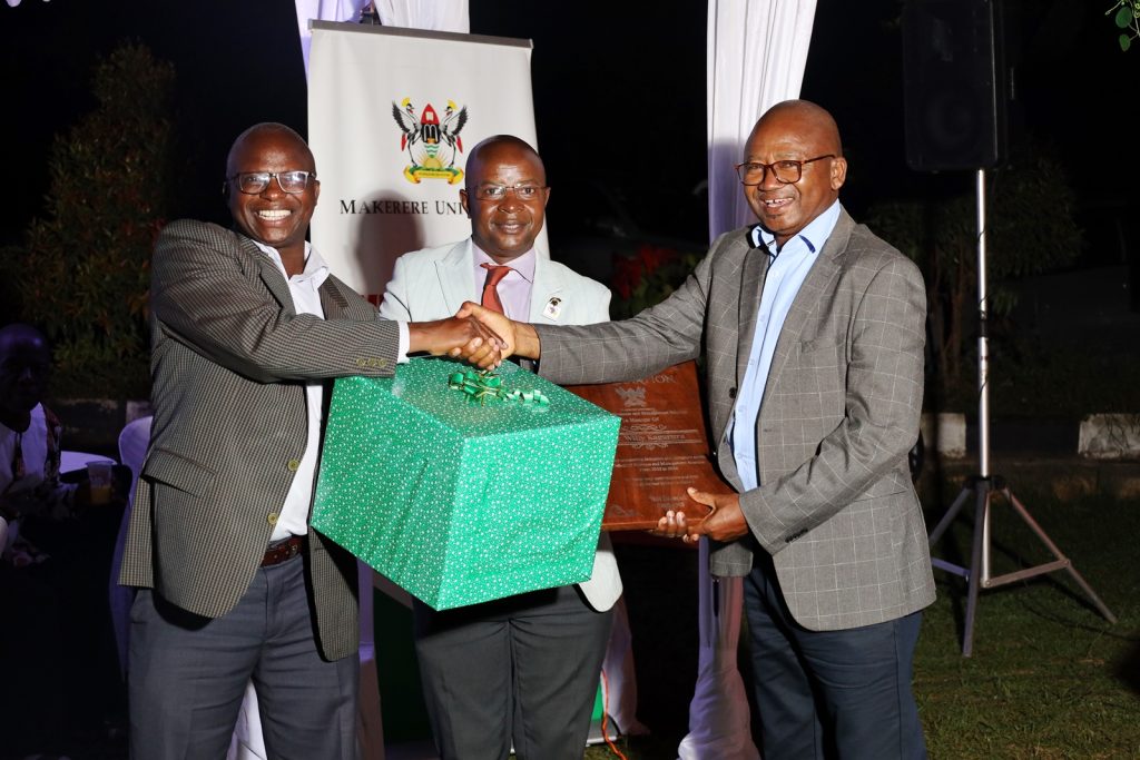 Dr. Willy Kagarura (Right) receives his gift from Prof. Edward Bbaale (Centre) and Prof. James Wokadala (Left). College of Business and Management Sciences (CoBAMS) celebrates retiring staff and former leaders, 13th September 2024, Makerere University, Kampala Uganda, East Africa.