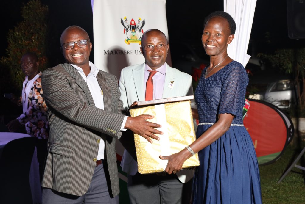 Ms. Josephine Apolot Opolot (Right) receives his gift from Prof. Edward Bbaale (Centre) and Prof. James Wokadala (Left). College of Business and Management Sciences (CoBAMS) celebrates retiring staff and former leaders, 13th September 2024, Makerere University, Kampala Uganda, East Africa.