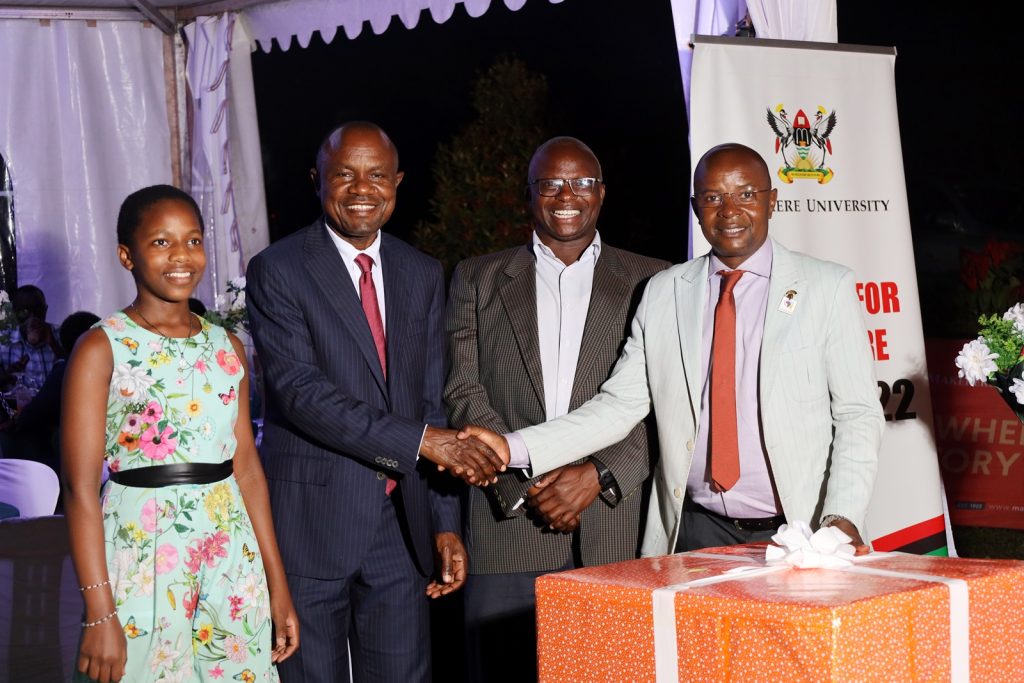 Right to Left: Prof. Edward Bbaale and Prof. James Wokadala hand over the gift to Prof. Eria Hisali and a member of his family. College of Business and Management Sciences (CoBAMS) celebrates retiring staff and former leaders, 13th September 2024, Makerere University, Kampala Uganda, East Africa.