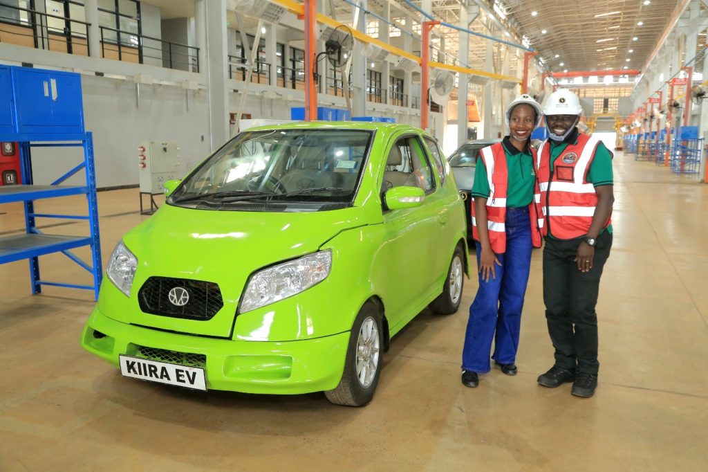 Dr. Peter Babyenda (Right) and a member of the team pose with the flagship two-seater Kiira EV. EfD-Mak Team and Inclusive Green Economy (IGE) fellows led by Uganda’s Policy Engagement Specialist Dr. Peter Babyenda visit Uganda’s Pioneer Motor Vehicle Company engaged in the production of Electric and solar powered vehicles – the Kiira Motors Corporation (KMC), 17th September 2024, Jinja, East Africa.