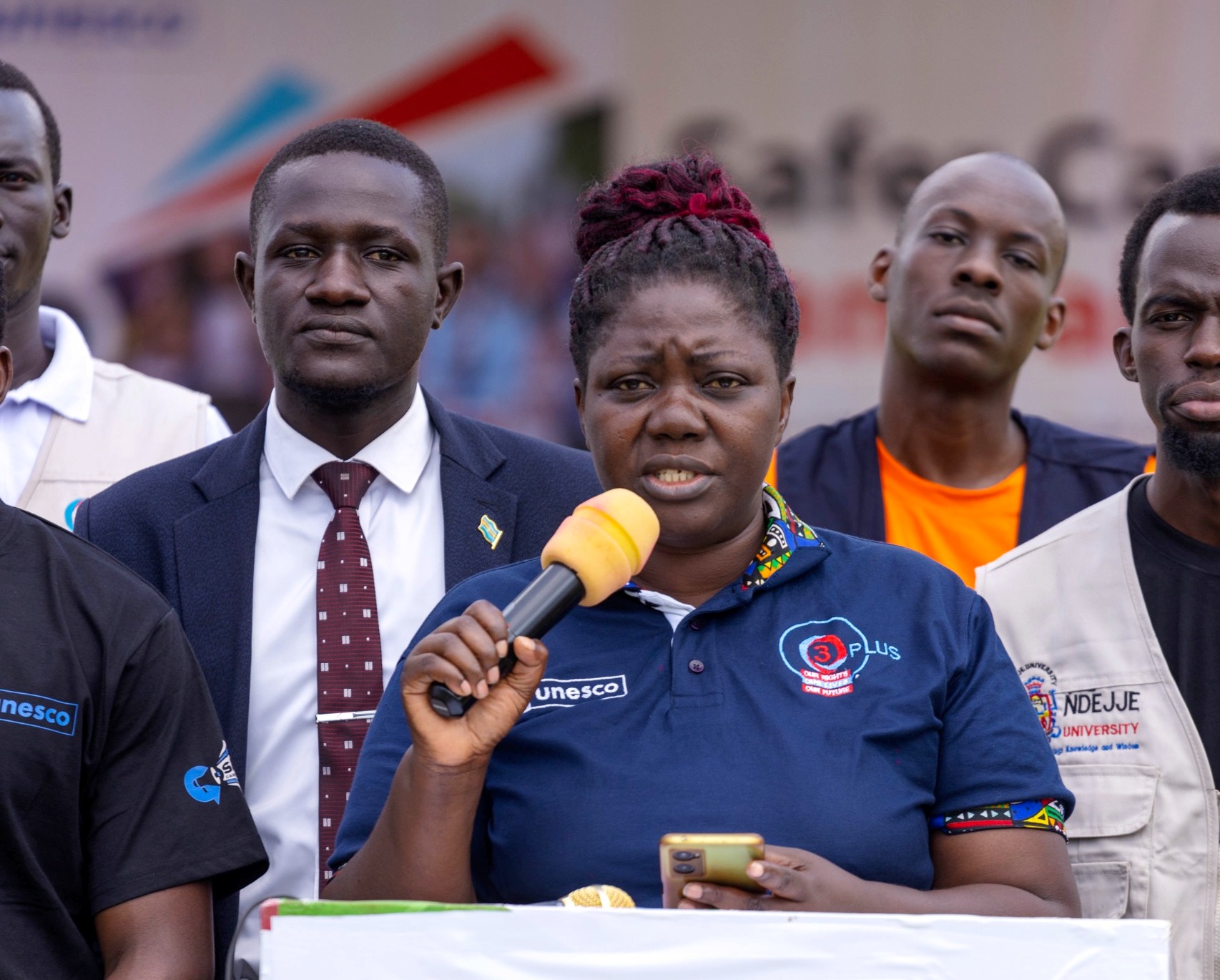 Dr. Primrose Nakazibwe (holding microphone) presents on behalf of the O3 Plus Focal Persons. Launch of the "Safer Campuses Campaign," aimed at shattering the silence surrounding Gender-Based Violence (GBV) in partnership with UNESCO, 4th October 2024, Freedom Square, Makerere University, Kampala Uganda, East Africa.