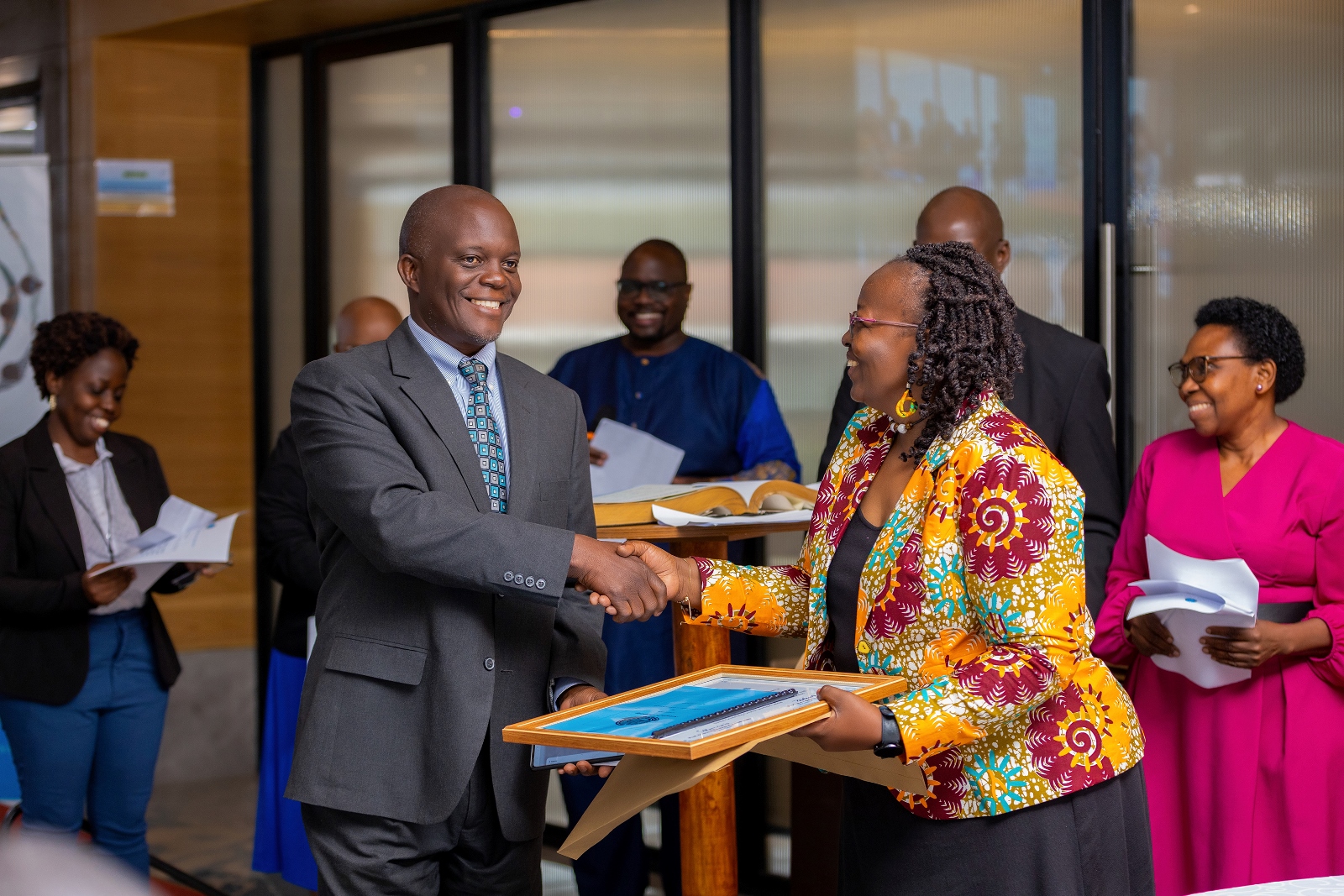 Dr. Fredrick Edward Makumbi receives a certificate of members from the UNAS president Prof. Grace Bantebya. Four Makerere University School of Public Health (MakSPH) faculty induction into the 2024 Uganda National Academy of Sciences (UNAS) fellowship, 1st November 2024, Four Points by Sheraton, Kampala Uganda, East Africa.