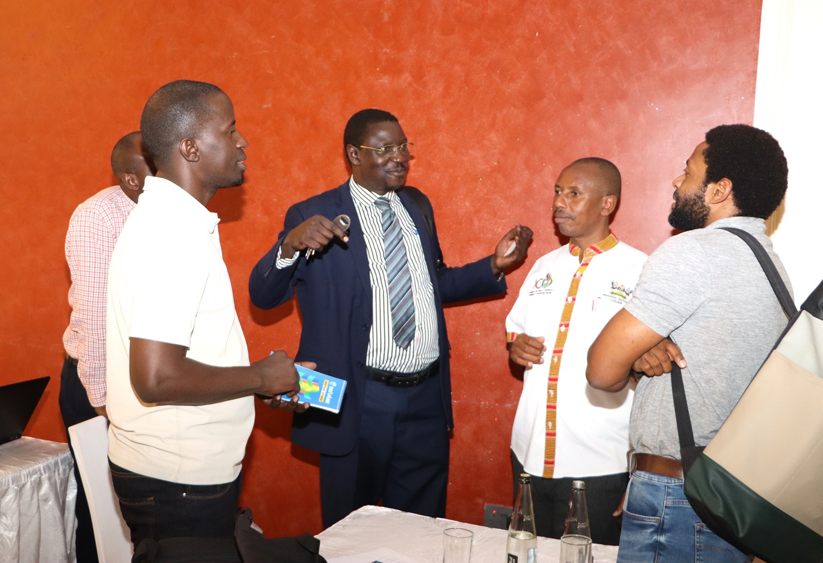 The Quality Assurance Director Dr. Cyprian Misinde (C) interacts with staff after the presentations on 1st November 2024. Makerere University College of Humanities and Social Sciences (CHUSS) Staff Retreat, 1st-2nd November 2024, Nican Resort Hotel, Seguku Entebbe Road, Kampala Uganda, East Africa.