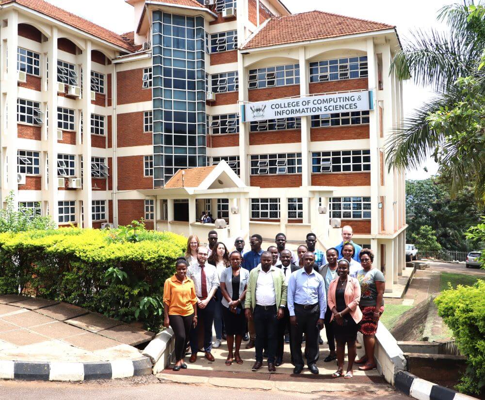 Participants posing for Group photo in front of Block A, College of Computing and Information Sciences. Two-day workshop on Artificial Intelligence (AI) for students and staff participating in the Erasmus+ exchange program, 11th-12th November 2024, Conference Room, Level 4, College of Computing and Information Sciences (CoCIS), Makerere University, Kampala Uganda, East Africa.