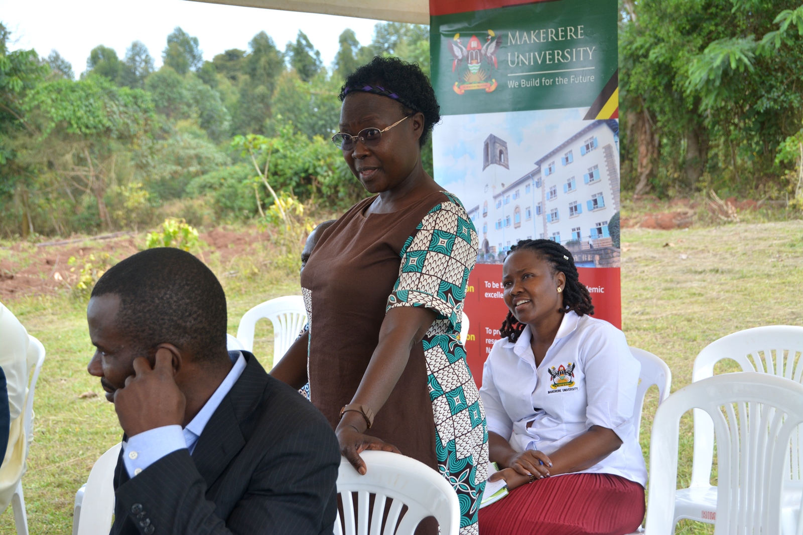 Dr. Josephine Asaete (standing) addressed the gathering about the intention of the outreach. Stakeholder Platform: Collaborative Knowledge Co-Creation and Sharing for livestock feed Climate-Smart Innovations in Uganda, one of four-year collaborative research project activities titled, “Building Capacity for Innovation and Advancement of Climate Smart Agriculture in East and Southern Africa” (CICSA-E&SA) implemented by Makerere University (CoVAB, CAES, CEES) in partnership with the Norwegian University of Life Sciences (Norway), Maseno University (Kenya), and LUANAR and DARS (Malawi), funded by the Norwegian Agency for International Cooperation and Quality Enhancement in Higher Education (Diku). Farmer Field Day, 20th November 2024, Our Lady of Assumption Mitala Maria Parish in Buwama, Mpigi District, Uganda, East Africa.