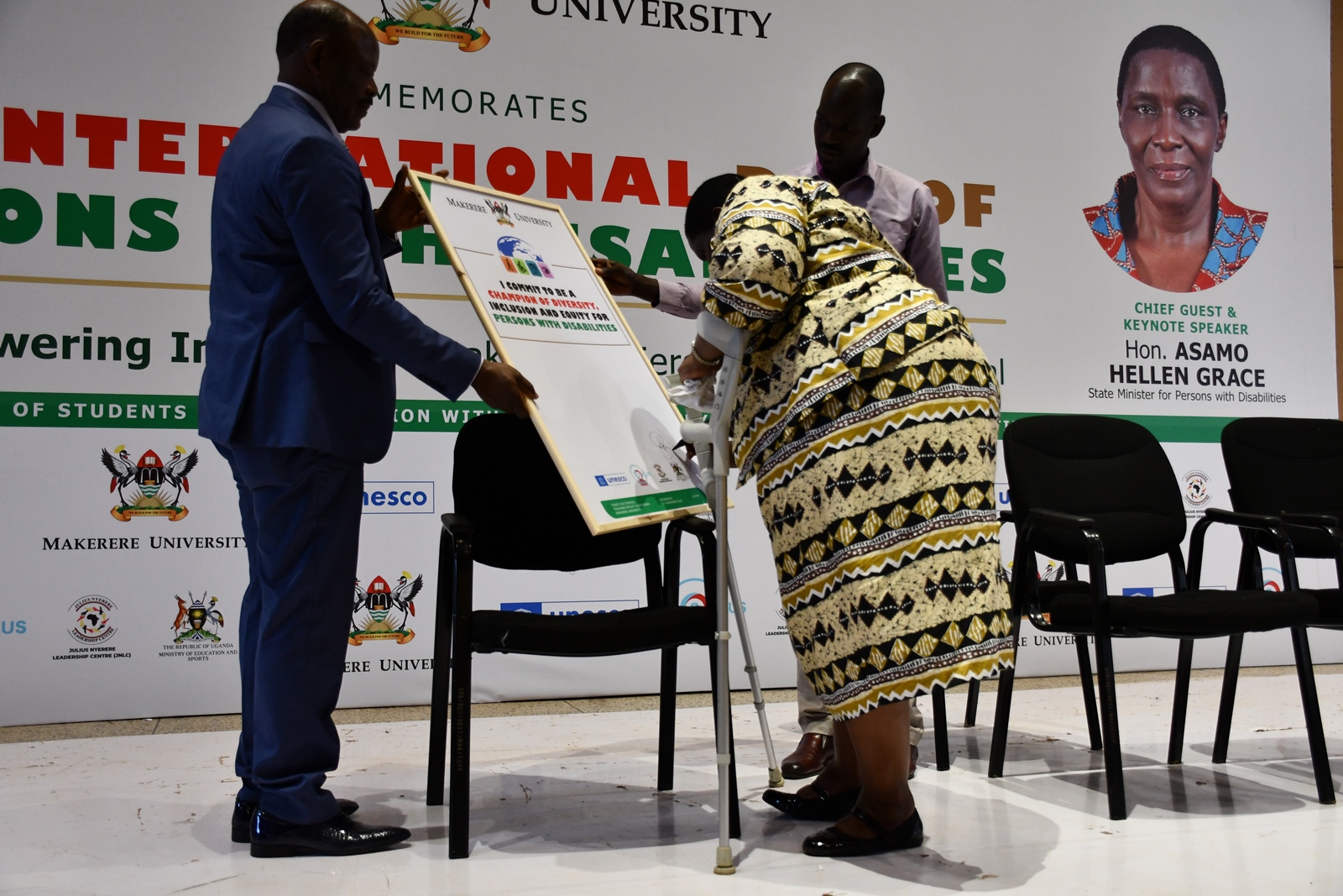 Hon. Hellen Asamo, signing a commitment card to continue supporting inclusivity at Makerere University and the country as a whole. Office of the Dean of Students and the 90th Students' Guild-Ministry of Students with Disabilities inaugural International Day of Persons with Disabilities commemoration, 13th November 2024, Yusuf Lule Central Teaching Facility Auditorium, Makerere University, Kampala Uganda, East Africa.