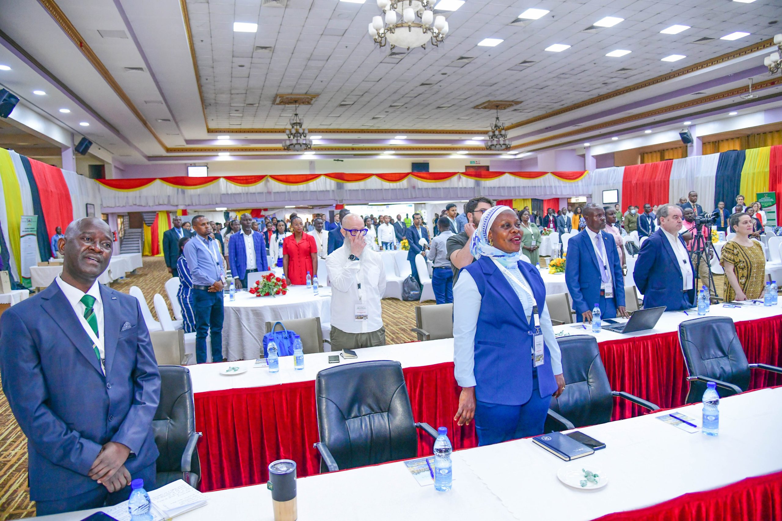 Prof. Yazidhi Bamutaze, Members of the National Organising Committee and a section of conference delegates stand for the anthems. College of Agricultural and Environmental Sciences (CAES), Makerere University in partnership with International Geographical Union (IGU) Commission of Biogeography and Biodiversity, the IGU Commission on African Studies, Uganda Geographical Association, and the International Association of Landscape Ecology (IALE) African Chapter, 3rd International Conference on Geographical Science for Resilient Communities, Ecosystems and Livelihoods under Global Environmental Change (GORILLA), Day 1, 4th December 2024, Hotel Africana, Kampala Uganda, East Africa.