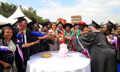 Ms. Elle Yang, Dr. Harriet Nabushawo and Dr. Jimmy Tibs Tumwesigye join some of the graduating candidates to cut cake. 240 students graduated with certificates and diplomas from the College of Education and External Studies (CEES) under the Love Binti Program, which offers training in fashion design and hairdressing, 13th December 2024, Impis Rugby Grounds, Makerere University, Kampala Uganda, East Africa.