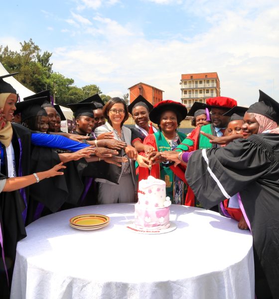 Ms. Elle Yang, Dr. Harriet Nabushawo and Dr. Jimmy Tibs Tumwesigye join some of the graduating candidates to cut cake. 240 students graduated with certificates and diplomas from the College of Education and External Studies (CEES) under the Love Binti Program, which offers training in fashion design and hairdressing, 13th December 2024, Impis Rugby Grounds, Makerere University, Kampala Uganda, East Africa.