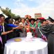 Ms. Elle Yang, Dr. Harriet Nabushawo and Dr. Jimmy Tibs Tumwesigye join some of the graduating candidates to cut cake. 240 students graduated with certificates and diplomas from the College of Education and External Studies (CEES) under the Love Binti Program, which offers training in fashion design and hairdressing, 13th December 2024, Impis Rugby Grounds, Makerere University, Kampala Uganda, East Africa.