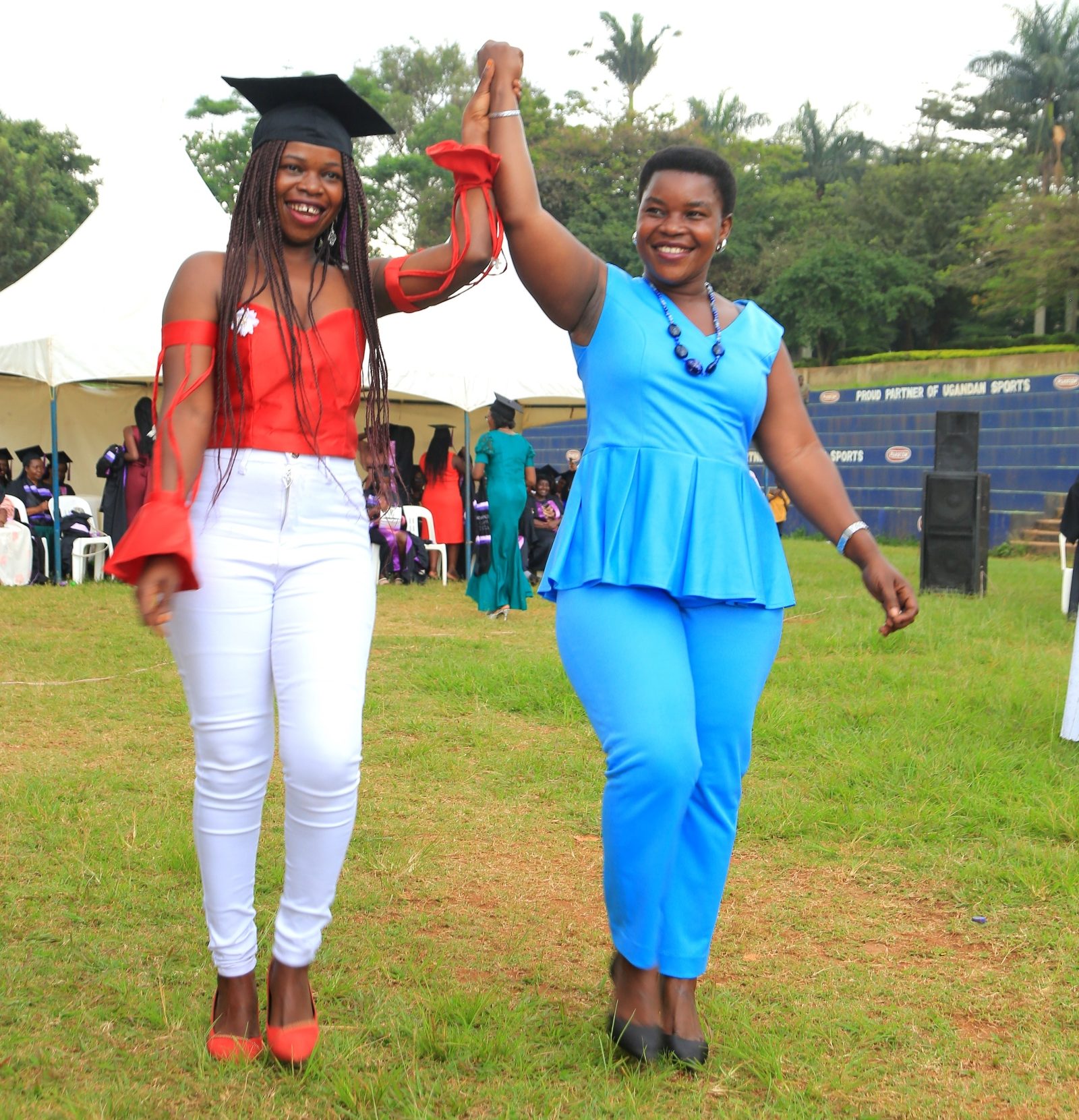 Some of the graduating candidates show off their creations. 240 students graduated with certificates and diplomas from the College of Education and External Studies (CEES) under the Love Binti Program, which offers training in fashion design and hairdressing, 13th December 2024, Impis Rugby Grounds, Makerere University, Kampala Uganda, East Africa.