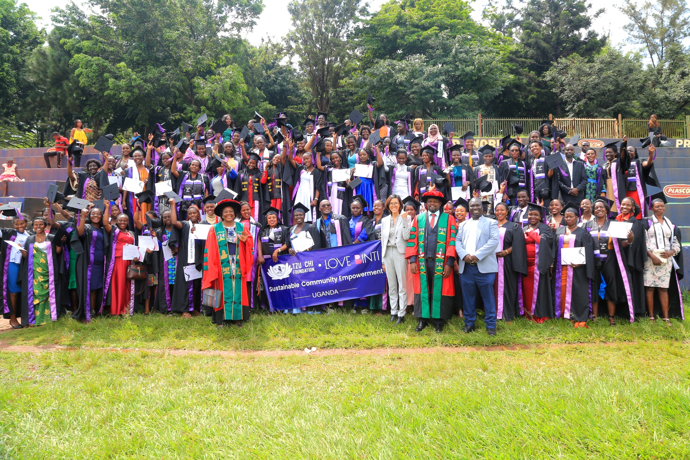 Dr. Harriet Nabushawo, Ms. Elle Yang, Dr. Jimmy Tibs Tumwesigye and Mr. Joseph Watuleke pose with graduating candidates. 240 students graduated with certificates and diplomas from the College of Education and External Studies (CEES) under the Love Binti Program, which offers training in fashion design and hairdressing, 13th December 2024, Impis Rugby Grounds, Makerere University, Kampala Uganda, East Africa.