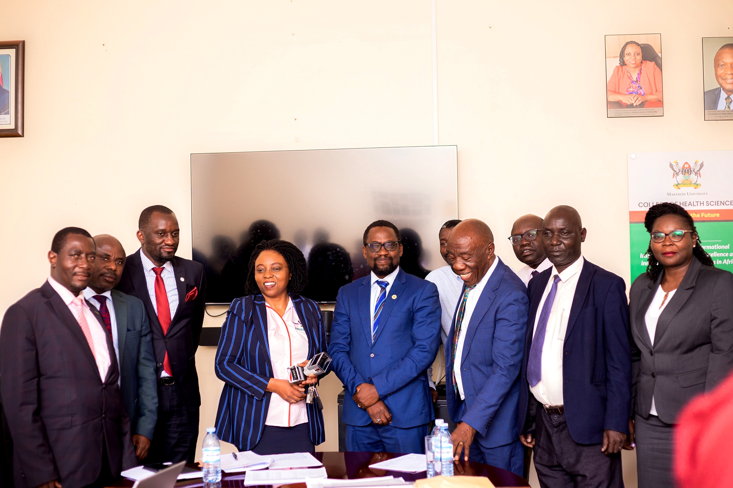 Left to Right: Mr. Evarist Bainomugisha, Mr. Deus Tayari Mujuni, Mr. Simon Kizito, Prof. Damalie Nakanjako, Prof. Bruce Kirenga, Dr. David Patrick Kateete (Rear), Prof. Henry Alinaitwe, Dr. Richard Idro (Rear), Mr. Patrick Akonyet and Prof. Annettee Nakimuli at the handover ceremony on 2nd December 2024. Handover of Principal Office by Prof. Damalie Nakanjako to Assoc. Prof. Bruce Kirenga, 2nd December 2024, College Boardroom, College of Health Sciences (CHS), Makerere University, New Mulago Hospital Complex, Kampala Uganda, East Africa.