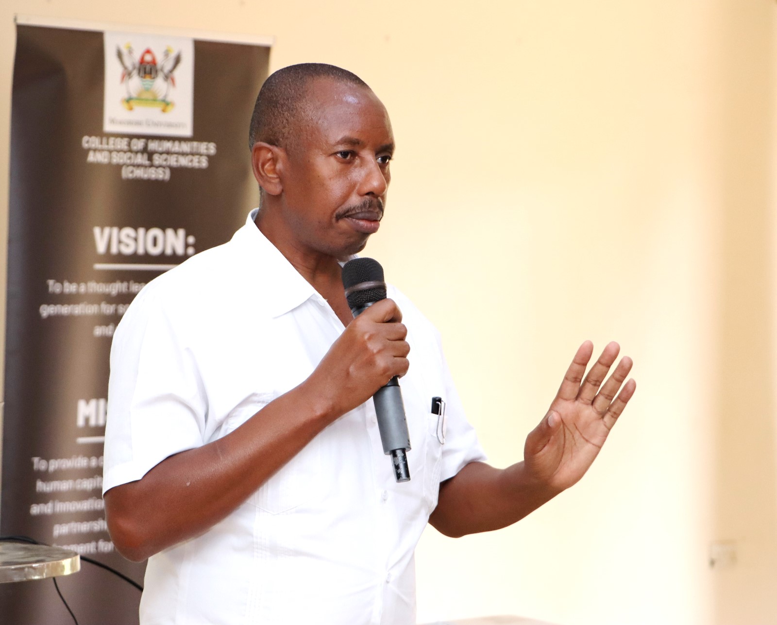 Dr. Gilbert Gumoshabe presenting on Customer care. The College of Humanities and Social Sciences (CHUSS), Makerere University first-ever non-academic staff retreat, December 7-8, 2024, Grand Global Hotel, Kikoni, Kampala Uganda, East Africa.