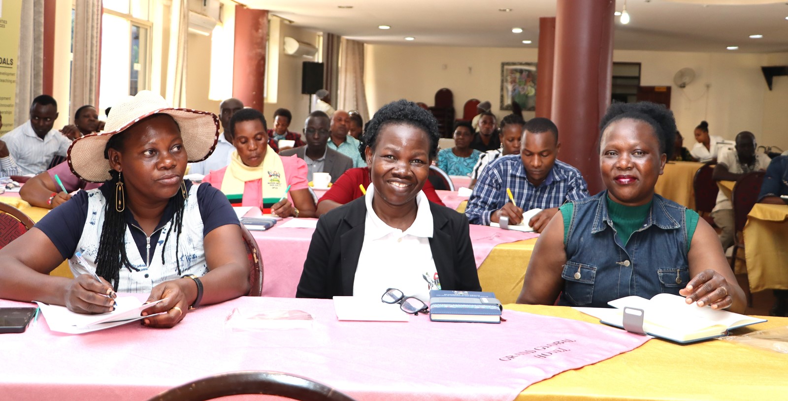 Some staff attending the training react to proceedings. The College of Humanities and Social Sciences (CHUSS), Makerere University first-ever non-academic staff retreat, December 7-8, 2024, Grand Global Hotel, Kikoni, Kampala Uganda, East Africa.