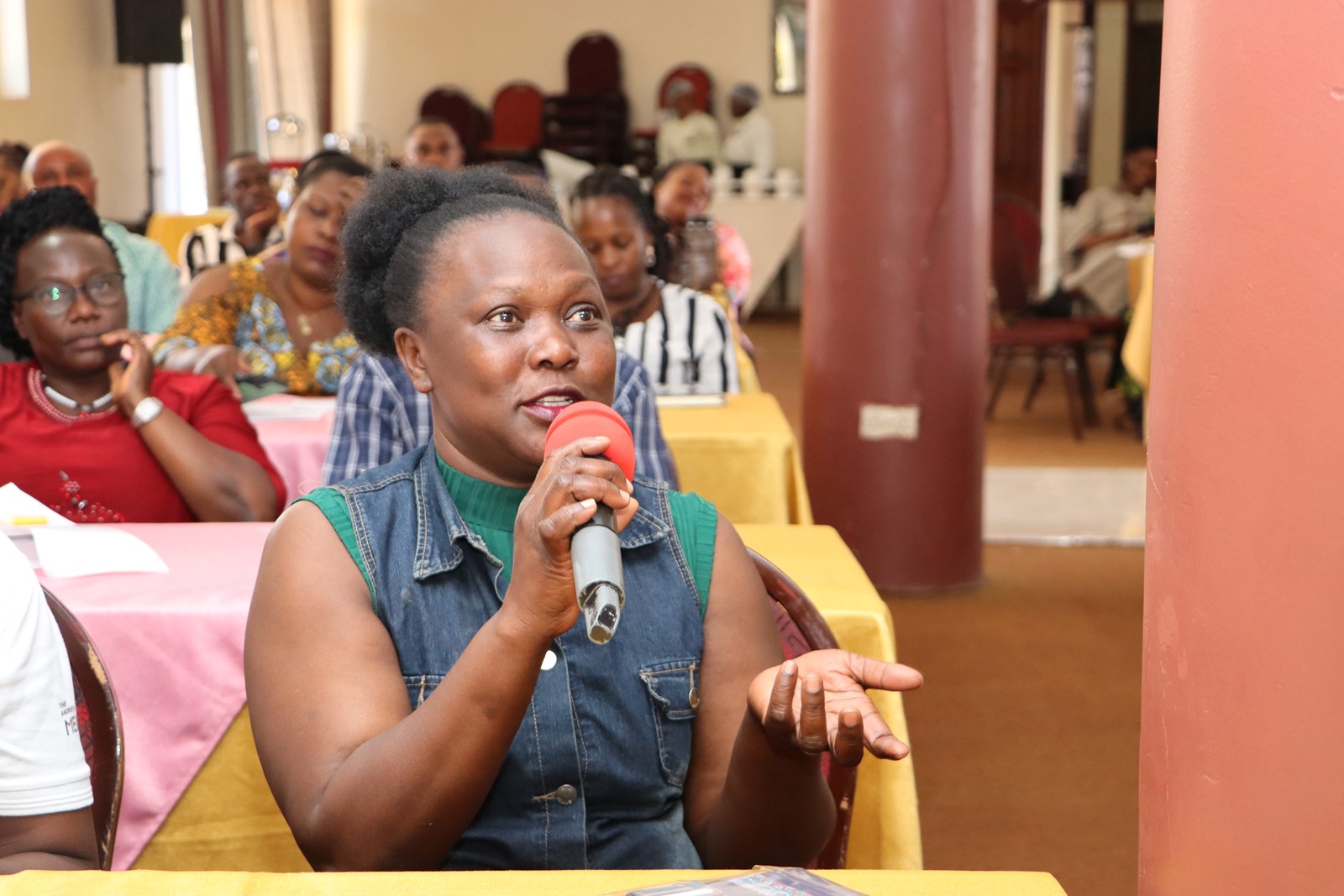 Custodian Rebecca Talikaza contributes during the discussion. The College of Humanities and Social Sciences (CHUSS), Makerere University first-ever non-academic staff retreat, December 7-8, 2024, Grand Global Hotel, Kikoni, Kampala Uganda, East Africa.