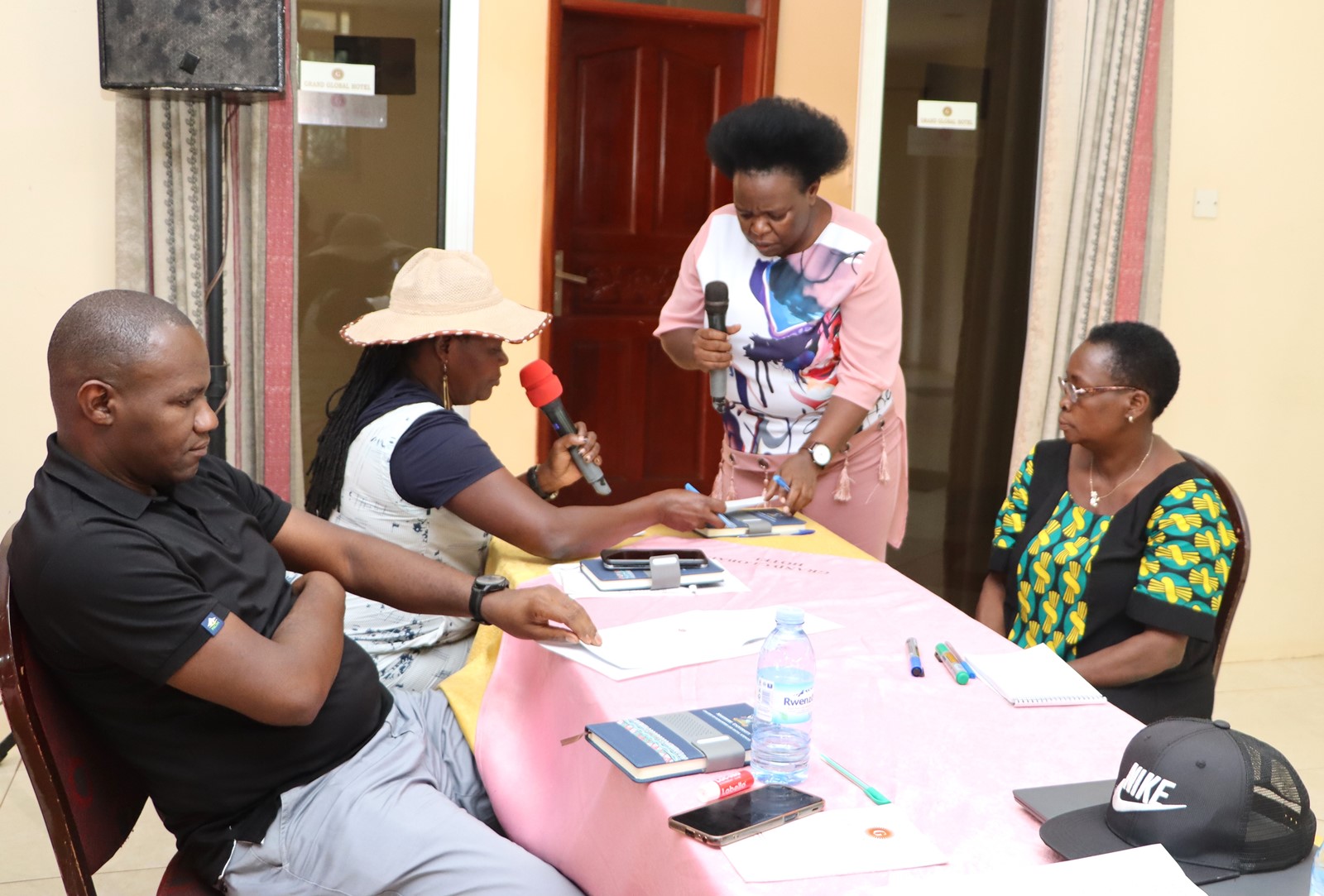 Staff in a role play of a student in the process of looking missing marks. The College of Humanities and Social Sciences (CHUSS), Makerere University first-ever non-academic staff retreat, December 7-8, 2024, Grand Global Hotel, Kikoni, Kampala Uganda, East Africa.