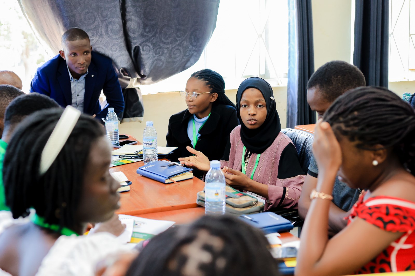 Ronald Ssazi listens in on Student Leaders engaged in a group activity. Konrad Adenauer Stiftung-Julius Nyerere Leadership Centre (JNLC) Peace and Security Leadership Training for Finalists and Graduating former Student Leaders in Different Universities in Uganda, Day Two, 4th December 2024, Telepresence Centre, Senate Building, Makerere University, Kampala, East Africa.