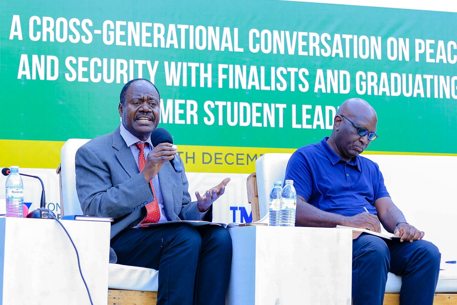 Prof. Julius Kiiza (Left) delivers his remarks on servant Leadership. Right is Prof. Philip Kasaija. Konrad Adenauer Stiftung-Julius Nyerere Leadership Centre (JNLC) Peace and Security Leadership Training for Finalists and Graduating former Student Leaders in Different Universities in Uganda, Day Three, 5th December 2024, JNLC Gardens, Pool Road, Makerere University, Kampala Uganda, East Africa.