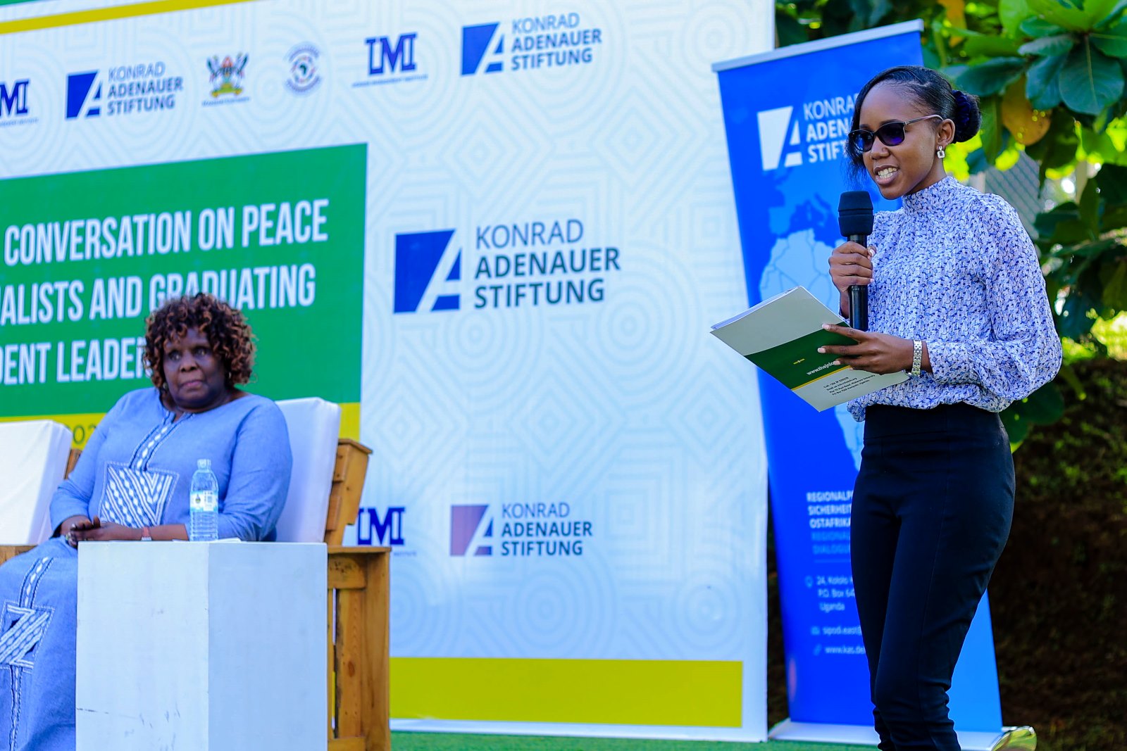 Ms. Angella Kasekende (Right) delivers her remarks at the Ekyooto. Left is Dr. Nansozi Muwanga. Konrad Adenauer Stiftung-Julius Nyerere Leadership Centre (JNLC) Peace and Security Leadership Training for Finalists and Graduating former Student Leaders in Different Universities in Uganda, Day Three, 5th December 2024, JNLC Gardens, Pool Road, Makerere University, Kampala Uganda, East Africa.