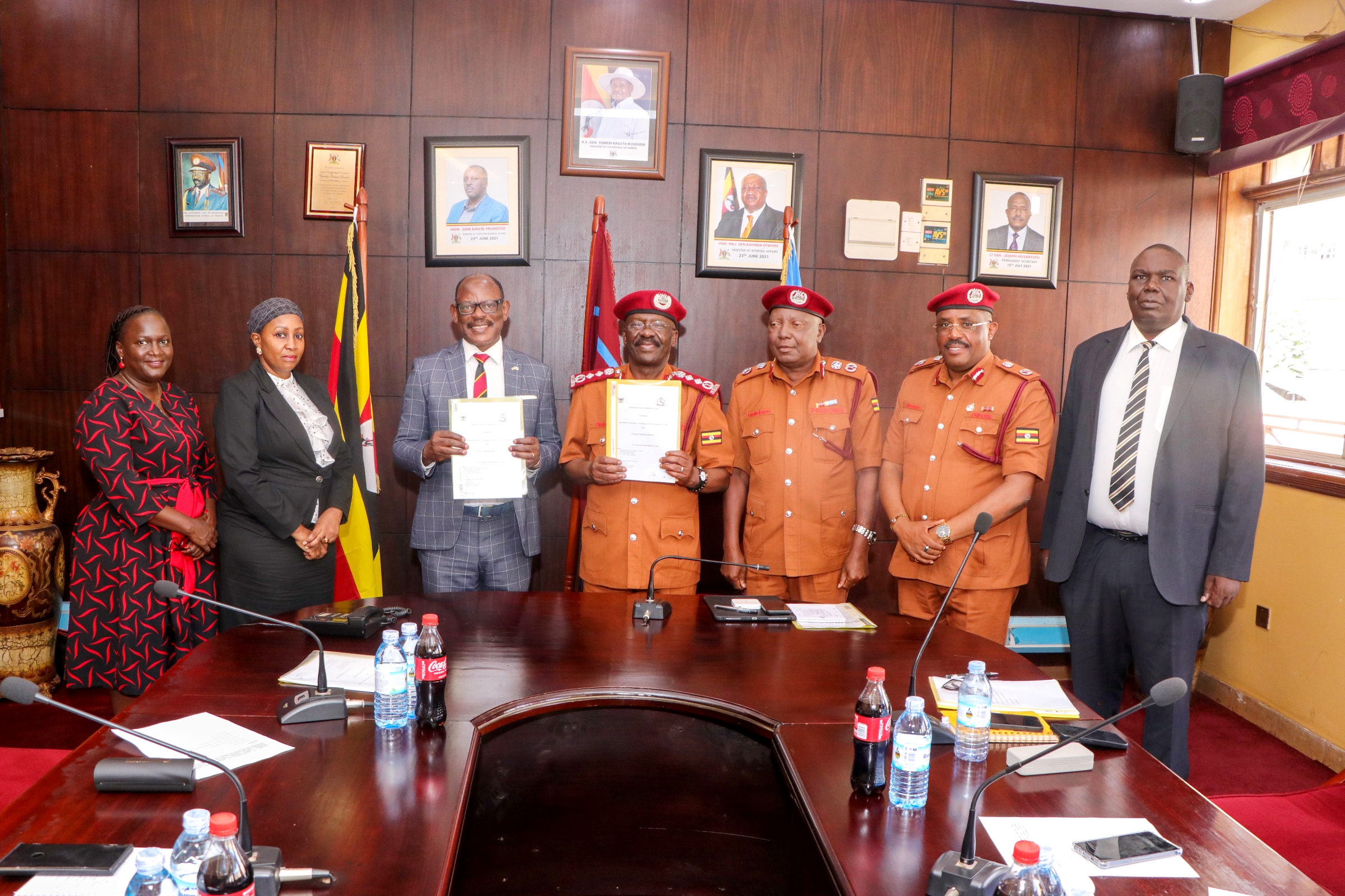 The Vice Chancellor-Prof. Barnabas Nawangwe (3rd Left) and Commissioner General Uganda Prisons Service (UPS)-Dr. Johnson Byamugisha (Centre) flanked by Left to Right: Dr. Patricia Atim, Dr. Zahara Nampewo and UPS Officials show off the signed MoU on 10th December 2024. Makerere University and Uganda Prison Services (UPS) sign Memorandum of Understanding that paves way for Makerere University School of Law to undertake short trainings in administrative law for UPS staff, 10th December 2024, Kampala Uganda, East Africa.