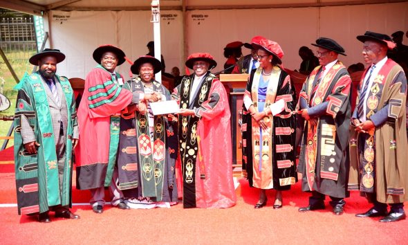 Hon. Dr. Crispus Kiyonga (C) and Hon. Dr. Joyce Moriku Kaducu (3rd L) present the Research Excellence Award to Prof. Mugisha Lawrence from the College of Veterinary Medicine, Animal Resources and Biosecurity (CoVAB) (2nd L). 75th Graduation Ceremony, Day 1, CoCIS, CEES, CoVAB and School of Law. 13th January 2025, Freedom Square, Makerere University, Kampala Uganda, East Africa.