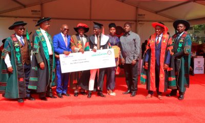 AR-Prof. Buyinza Mukadasi (4th L) and Chair Convocation-Mr. George Turyamureeba (3rd L) present the Award to Mubiru (C) as his parents (3rd & 4th R) as well as CoNAS Principal-Prof. Winston Tumps Ireeta (2nd R) and College Leadership witness. 75th Graduation Ceremony, Day 2, CoBAMS, CHS and CoNAS. 14th January 2025, Freedom Square, Makerere University, Kampala Uganda, East Africa.