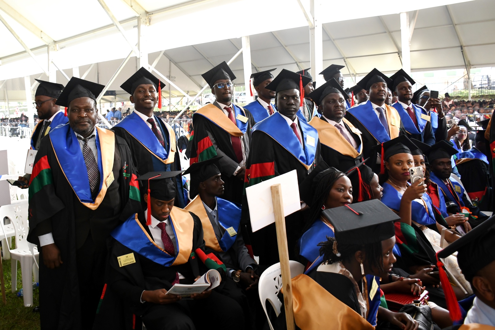 Masters Graduands stand as their names are read on Day 2. 75th Graduation Ceremony, Day 2, CoBAMS, CHS and CoNAS. 14th January 2025, Freedom Square, Makerere University, Kampala Uganda, East Africa.