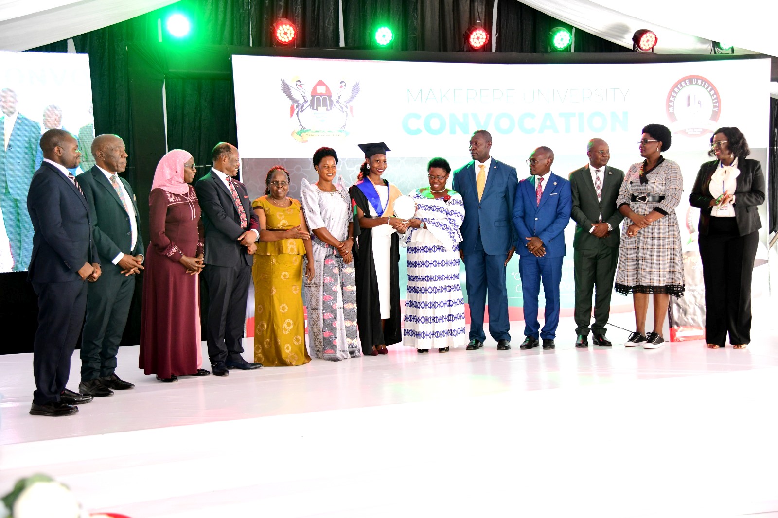 Hon. Dr. Joyce Moriku Kaducu presents the EPRC Award to the best-performing student in the Master of Economics program, Nalweere Alice. Convocation Luncheon, 75th Graduation Ceremony, Day 2, CoBAMS, CHS and CoNAS. 14th January 2025, Research, Teaching, Students Excellence Awards, Edge Road, Makerere University, Kampala Uganda, East Africa.