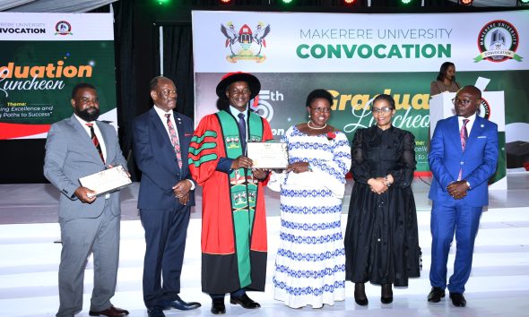 Hon. Dr. Joyce Moriku Kaducu (3rd R) presents the Mid-Career Award to Dr. Ssendawula Kasimu (3rd L) during the Convocation Luncheon. 75th Graduation Ceremony, Day 2, CoBAMS, CHS and CoNAS. 14th January 2025, Research, Teaching, Students Excellence Awards, Edge Road, Makerere University, Kampala Uganda, East Africa.