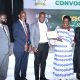 Hon. Dr. Joyce Moriku Kaducu (2nd R) presents the Teacher of the Year Award to Fredrick Kasalirwe (C) during the Convocation Luncheon. 75th Graduation Ceremony, Day 2, CoBAMS, CHS and CoNAS. 14th January 2025, Research, Teaching, Students Excellence Awards, Edge Road, Makerere University, Kampala Uganda, East Africa.