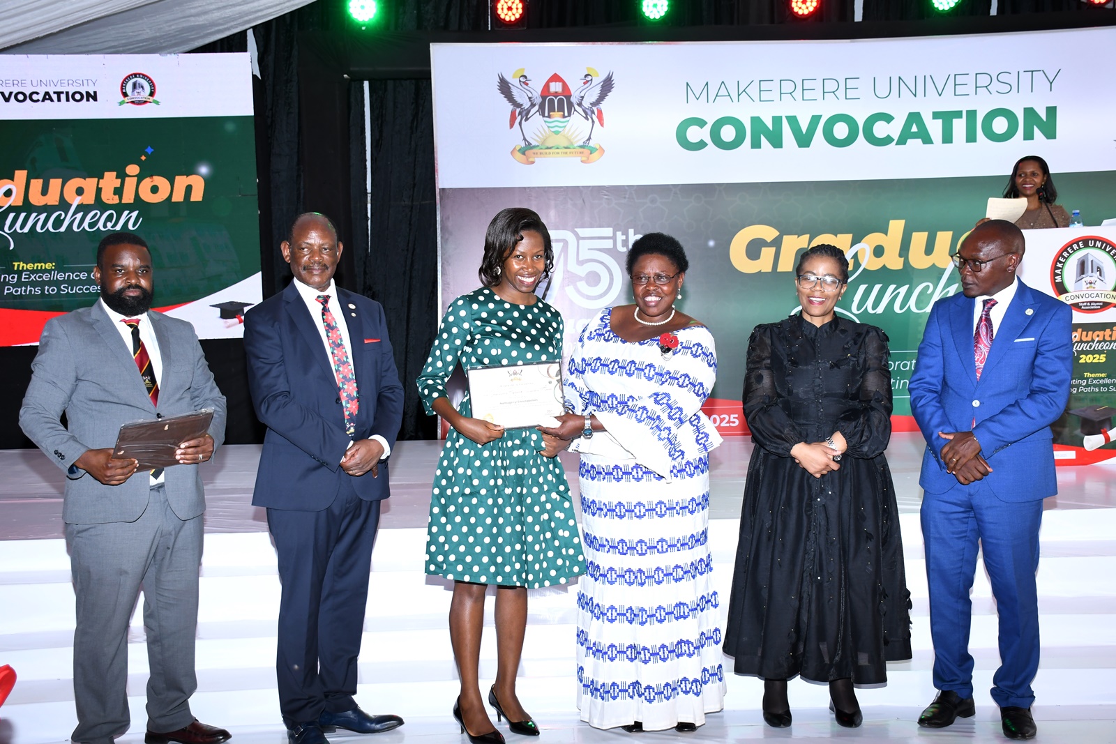 Hon. Dr. Joyce Moriku Kaducu (3rd R) presents the Award to Namugenyi Christabellah (3rd L). Convocation Luncheon, 75th Graduation Ceremony, Day 2, CoBAMS, CHS and CoNAS. 14th January 2025, Research, Teaching, Students Excellence Awards, Edge Road, Makerere University, Kampala Uganda, East Africa.