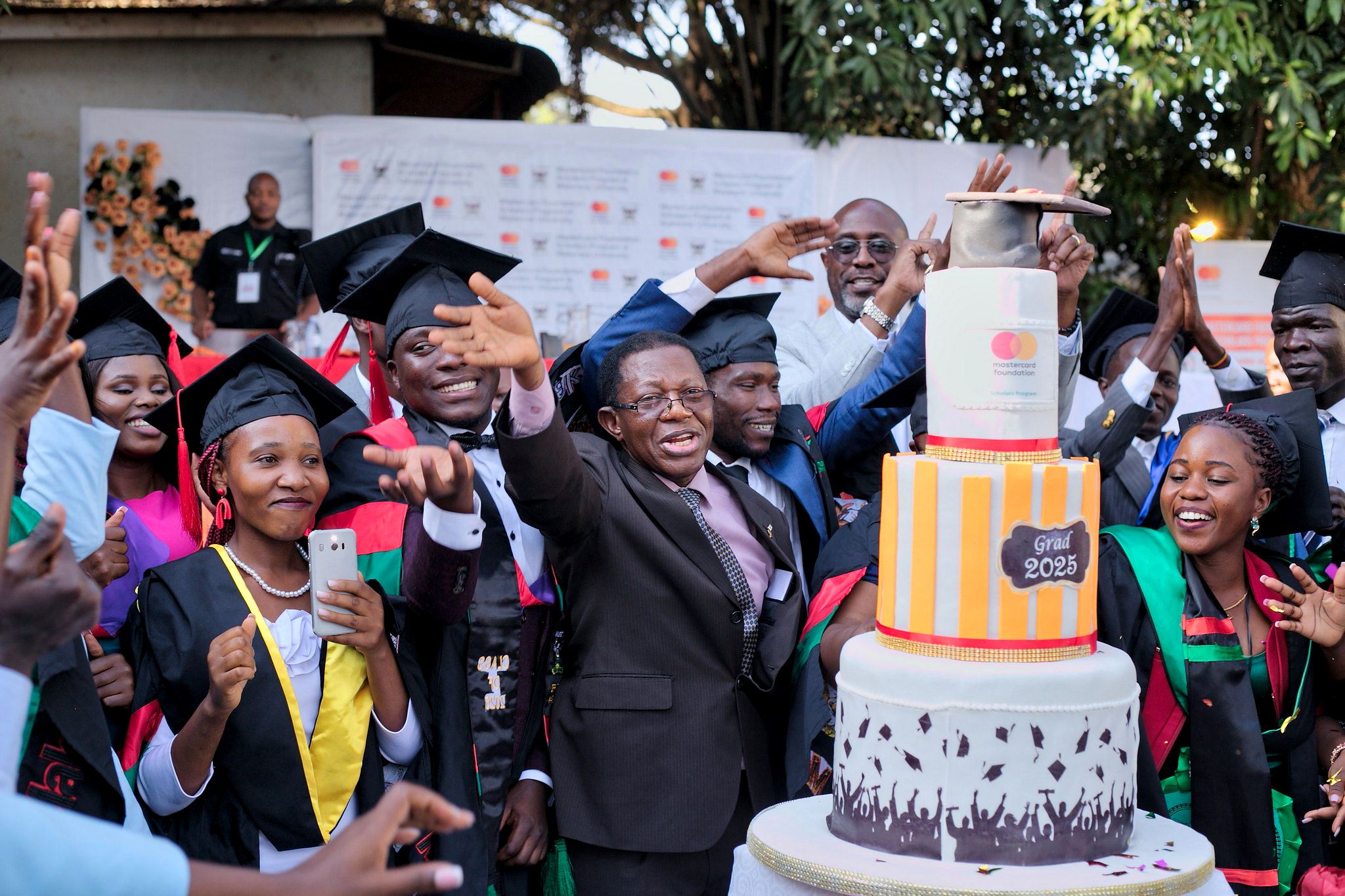 Graduates and officials cutting the cake. 75th Graduation Ceremony, Day 5, CAES, CEDAT and CHUSS. Celebration of completion of 36 Mastercard Foundation Scholars, 17th January 2025, Guest House, Makerere University, Kampala Uganda, East Africa.