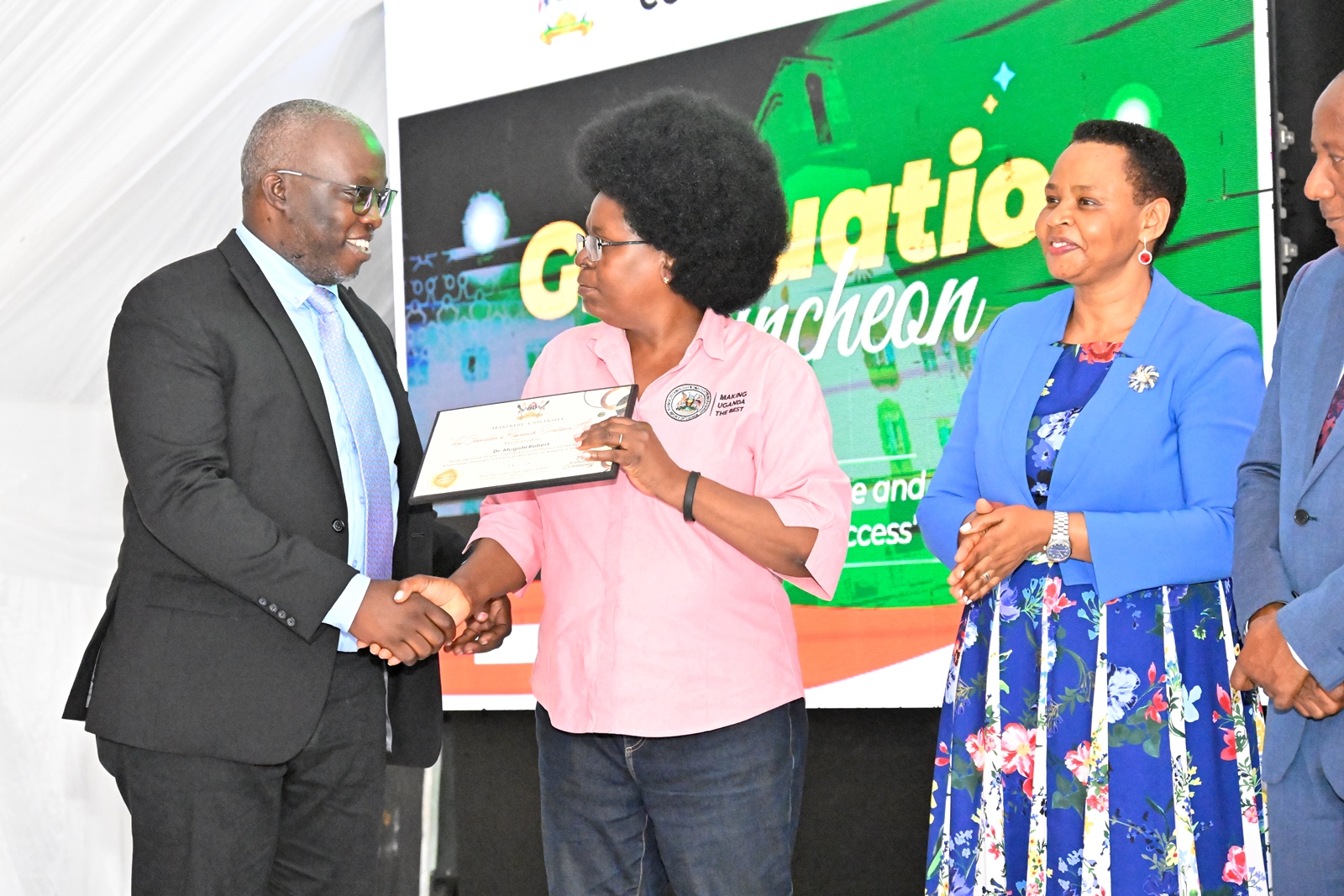 The Minister of Science, Technology and Innovation, Dr Monica Musenero Masanza presenting an Award to one of the Best Mid-Career Researchers from CAES, Dr Robert Mugabi. 75th Graduation Ceremony, Day 5, CAES, CEDAT and CHUSS. Convocation Luncheon, 17th January 2025, Edge Road, Makerere University, Kampala Uganda, East Africa.