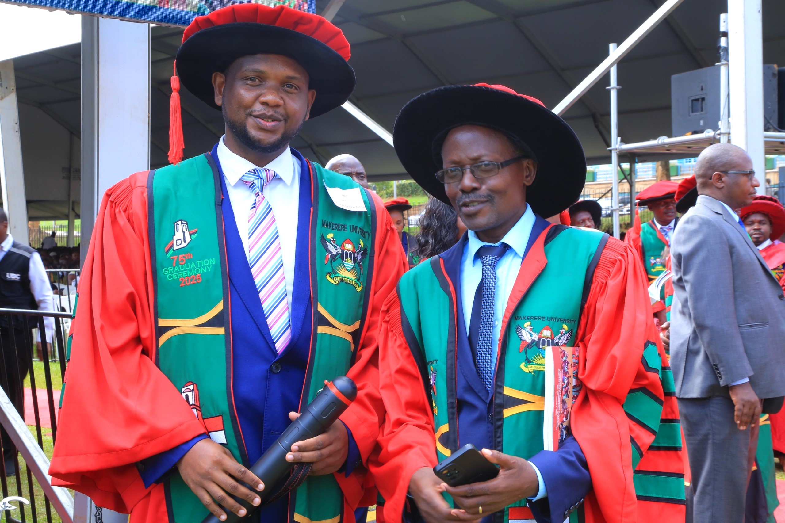 Dr Settumba Mukasa from the Department of Agricultural Production, CAES congratulates one of the PhD graduates. 75th Graduation Ceremony, Day 5, CAES, CEDAT and CHUSS. 17th January 2025, Freedom Square, Makerere University, Kampala Uganda, East Africa.