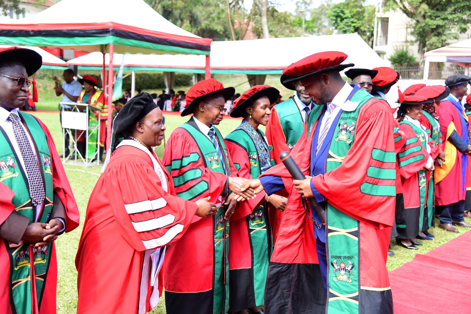 PhD Graduate Dr. Idd Ramathani is congratulated by staff from the College of Agricultural and Environmental Sciences (CAES) after being conferred upon his award on Day 5 of the 75th Graduation Ceremony. 75th Graduation Ceremony, Day 5, CAES, CEDAT and CHUSS. 17th January 2025, Freedom Square, Makerere University, Kampala Uganda, East Africa.