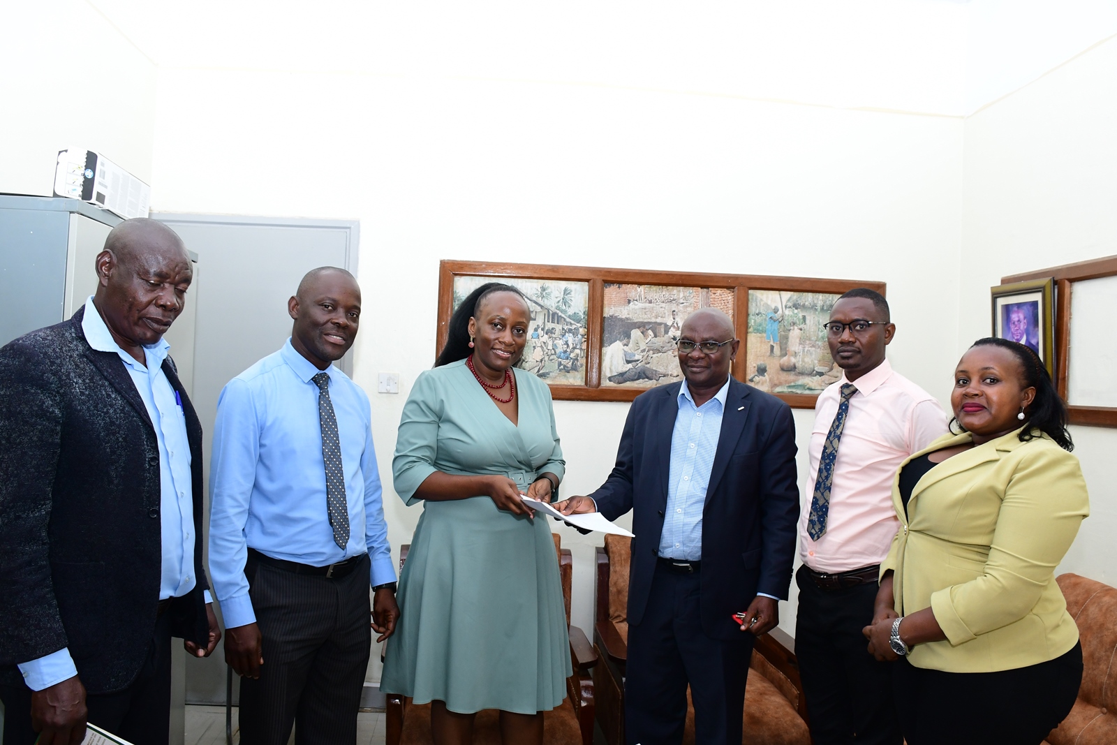 Dean School of Education-Prof. Mulumba Mathias (2nd L), Directorate of Human Resources' Mr. Patrick Mutebi (2nd R), Internal Audit Directorate's Ms. Mbabazi Winnie (R) and another official witness as Dr. John Ssentongo (3rd R) hands over to Dr. Marjorie Batiibwe (3rd L). Department of Science, Technical and Vocational Education (DSTVE), School of Education, College of Education and External Studies (CEES) transition in leadership from Dr. John Ssentongo to Dr. Marjorie Batiibwe, January 28, 2025, Makerere University, Kampala Uganda, East Africa.