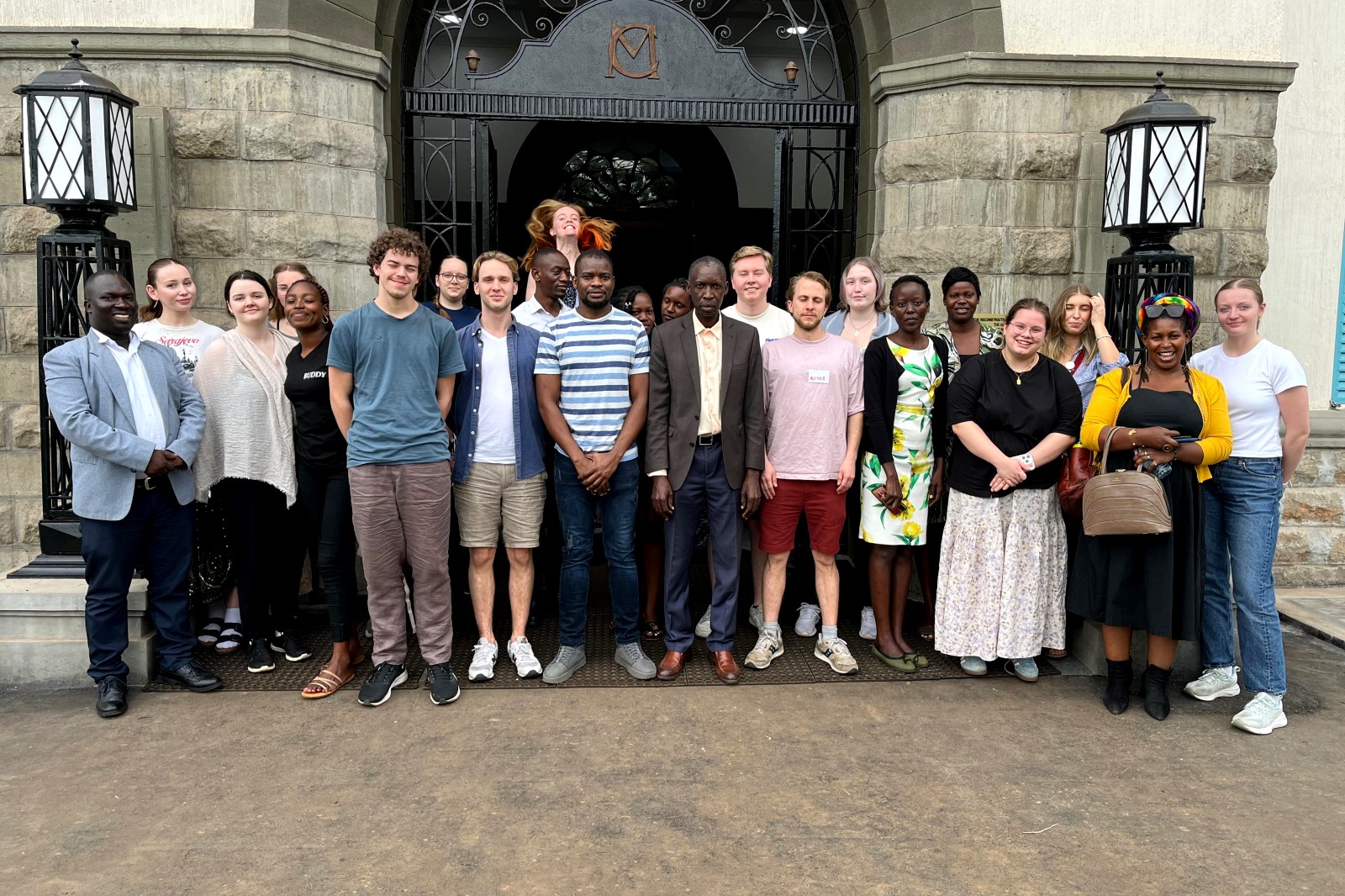 The Principal CEES, Prof. Anthony Muwagga Mugagga (C) poses for a group photo with CEES Staff and the exchange students.Department of Adult and Community Education, School of Distance and Lifelong Learning, College of Education and External Studies (CEES) hosting 17 exchange students from the University of Agder, Norway, as part of a one-month field course. Induction January 6th, 2025, Main Building, Makerere University, Kampala Uganda, East Africa.