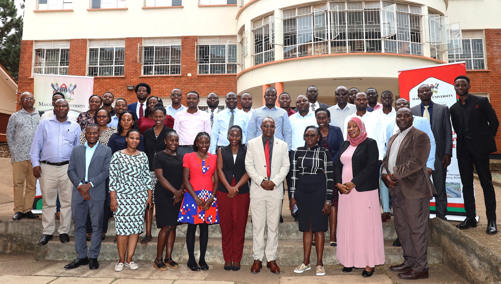 Prof. Edward Bbaale (Centre in suit) with facilitators and participants at the event. Public Investment Management (PIM) Centre of Excellence commencement of three-day training program titled "Essentials of Public Investment Management," 20th January 2025, Conference Room, Level 2, School of Business, the College of Business and Management Sciences (CoBAMS), Makerere University, Kampala Uganda, East Africa.