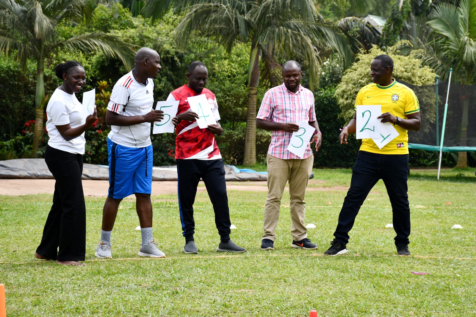 Prof. Ibrahim Mike Okumu (2nd R) with staff engaged in one of the games. School of Economics, College of Business and Management Sciences (CoBAMS), Makerere University, Kampala team-building activity, 15th January 2025, Buwatte, Wakiso, Uganda, East Africa.