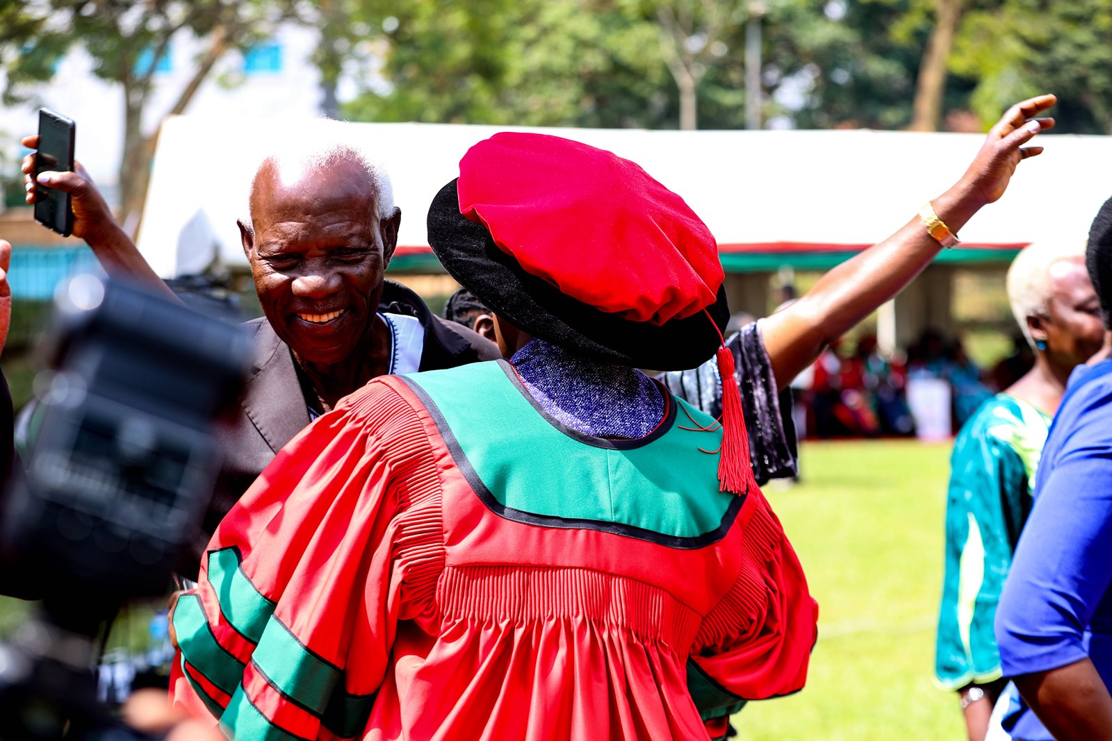 Ochola is welcomed by her father, Mzee Owino Vincent Olele on graduation day. 75th Graduation Ceremony, Day 2, CoBAMS, CHS and CoNAS. 14th January 2025, Freedom Square, Makerere University, Kampala Uganda, East Africa.