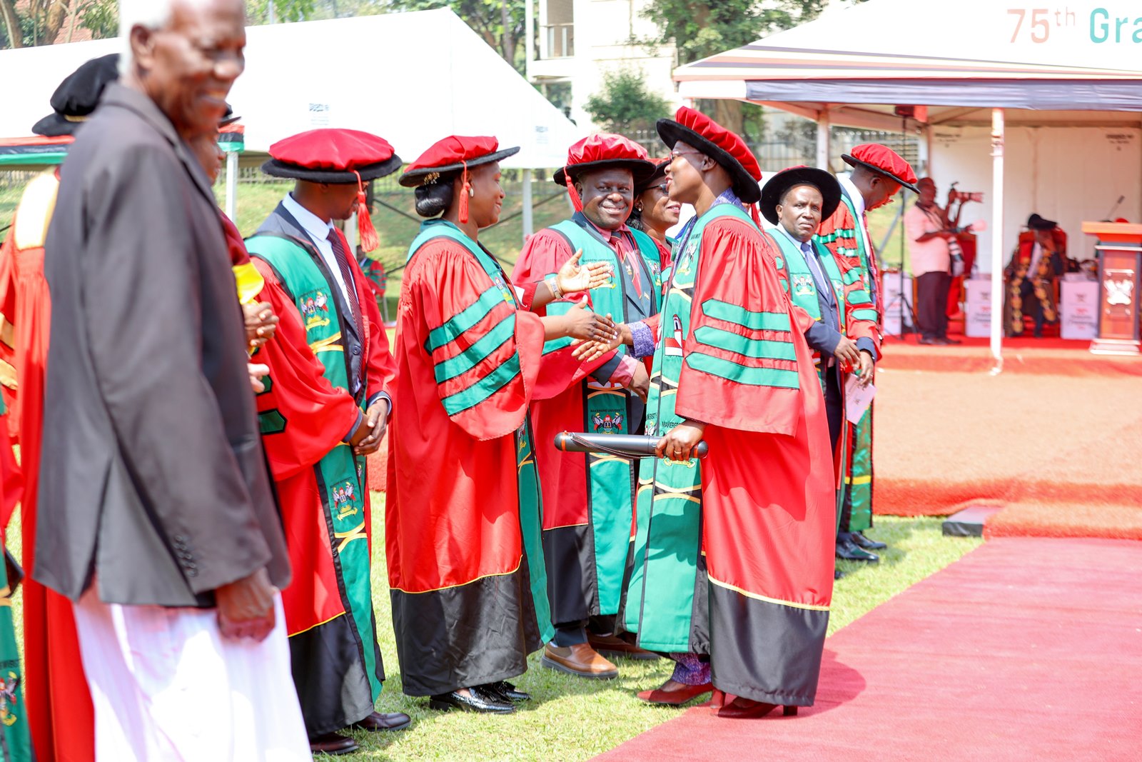 Dr. Roselline Achola on Graduation day being welcomed by her teachers following her PhD award. 75th Graduation Ceremony, Day 2, CoBAMS, CHS and CoNAS. 14th January 2025, Freedom Square, Makerere University, Kampala Uganda, East Africa.