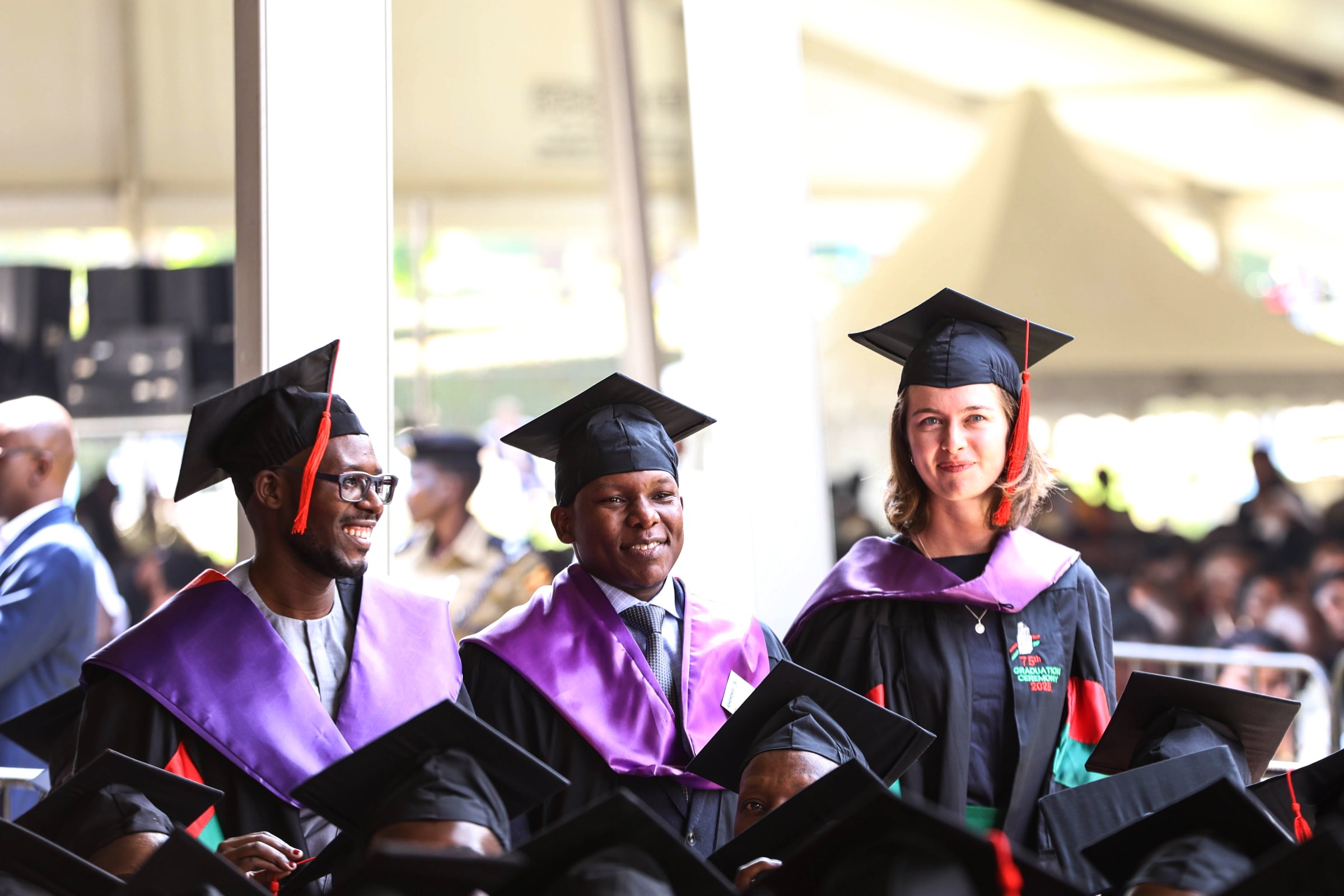 Laura Silovsky (Right) at the graduation ceremony alongside fellow graduands Juma Said Tusubila and Ssali Abdallah Yahya on Day 2 of the 75th Graduation Ceremony. 75th Graduation Ceremony, Day 2, CoBAMS, CHS and CoNAS. 14th January 2025, Freedom Square, Makerere University, Kampala Uganda, East Africa.