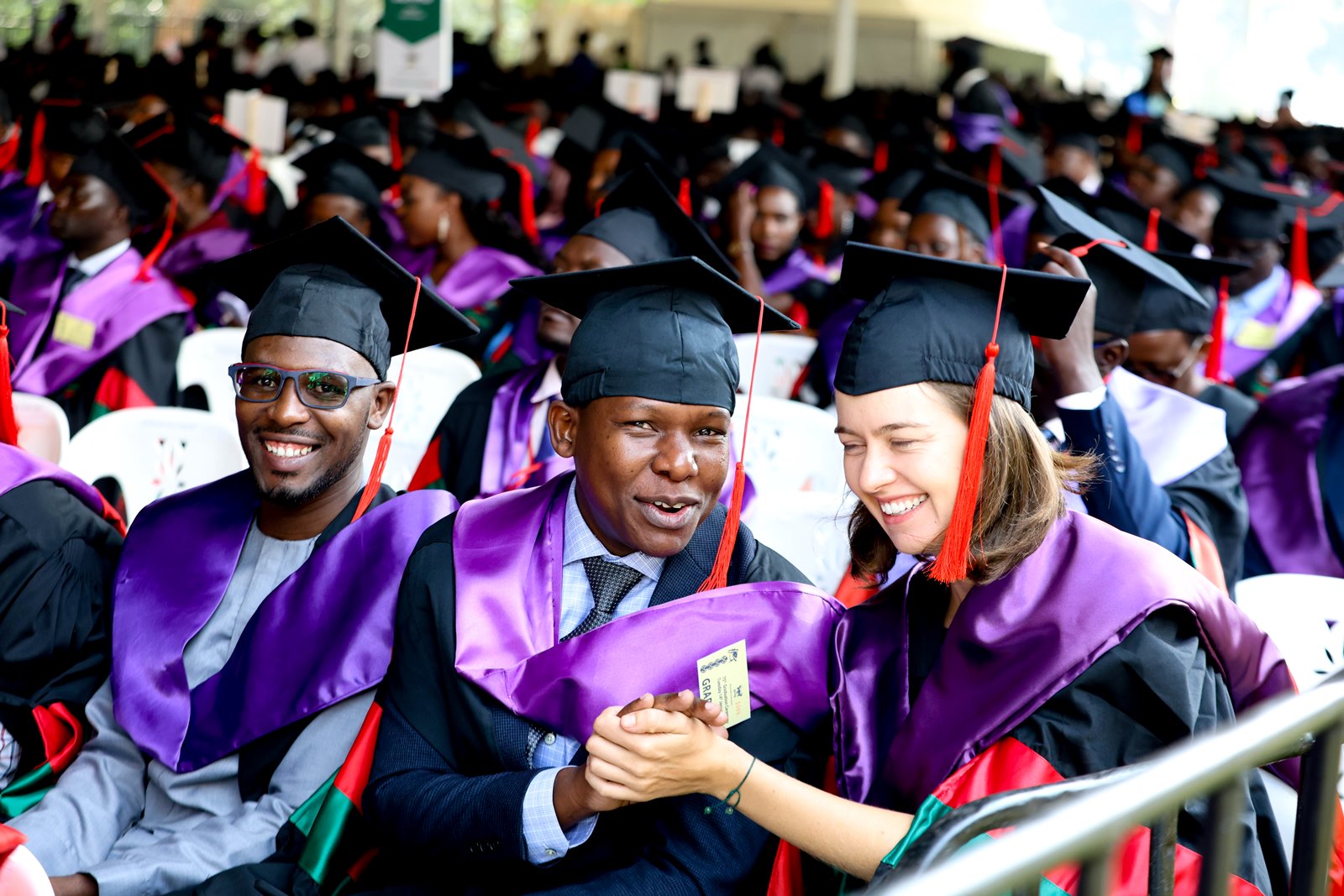 Laura Silovsky (Right) at the graduation ceremony alongside fellow graduands Juma Said Tusubila and Ssali Abdallah Yahya. 75th Graduation Ceremony, Day 2, CoBAMS, CHS and CoNAS. 14th January 2025, Freedom Square, Makerere University, Kampala Uganda, East Africa.