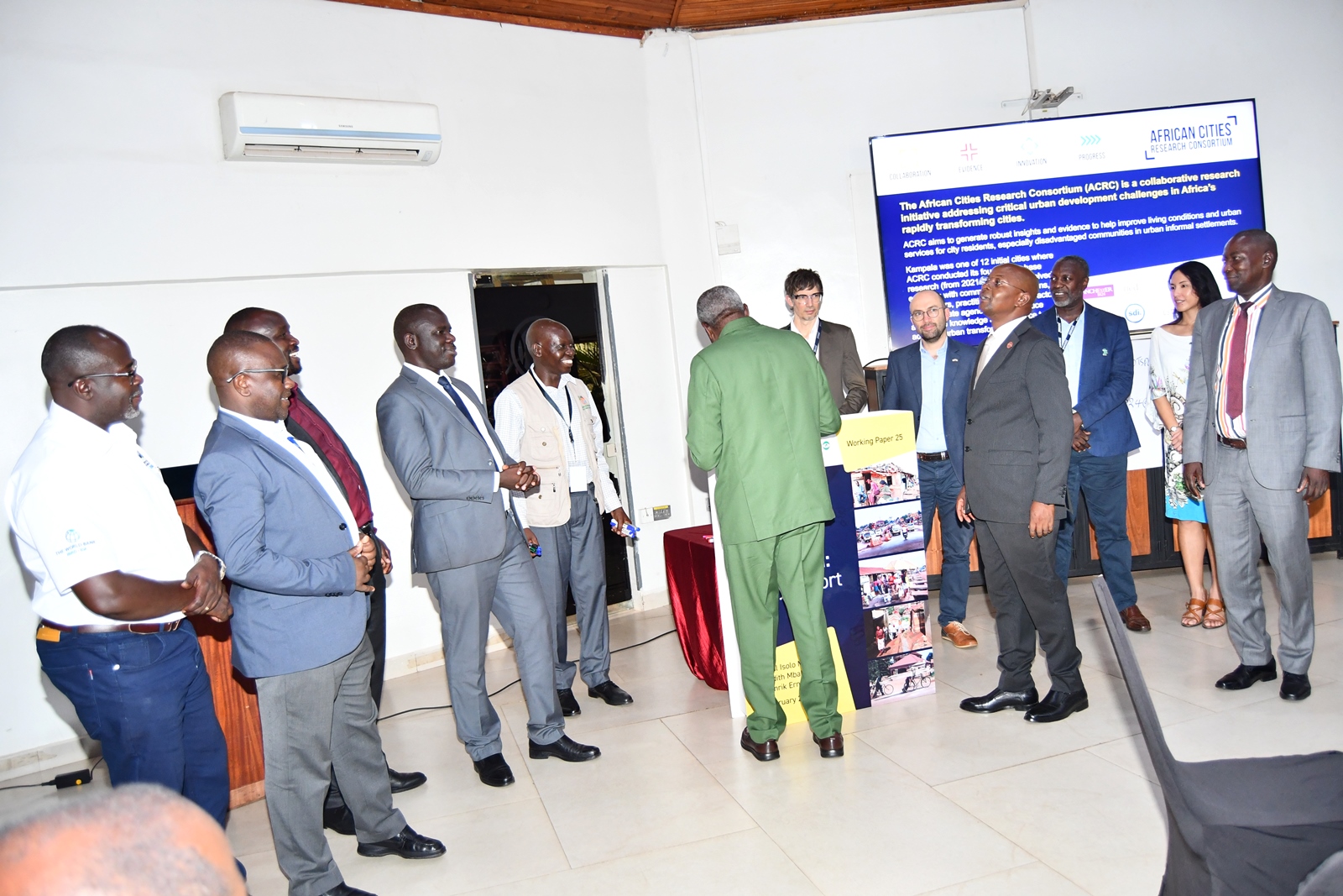 Hon. Mario Obiga Kania appending his signature on the report. Makerere University Urban Action Lab, College of Agricultural and Environmental Sciences (CAES) launch of comprehensive report, part of the African Cities Research Consortium (ACRC) program, detailing key challenges affecting urban development in Kampala, one of Africa’s fastest-growing cities, annual population growth rate of 5.6%, by Hon. Mario Obiga Kania, Minister of State for Urban Development, 13th February 2025, Fairway Hotel, Uganda, East Africa.