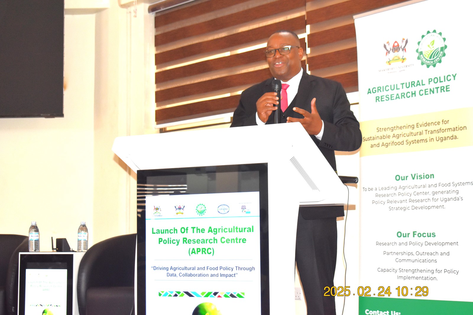 Dr Antony Chapoto briefing participants on the work of ANAPRI. Official launch of Agricultural Policy Research Centre (APRC), College of Agricultural and Environmental Sciences (CAES) by Uganda’s Minister of Agriculture, Animal Industry, and Fisheries (MAAIF), represented by Mr. Steven Byantwale, the Commissioner for Crop Protection, 24th February 2025, Makerere University School of Public Health Auditorium, Kampala Uganda, East Africa.